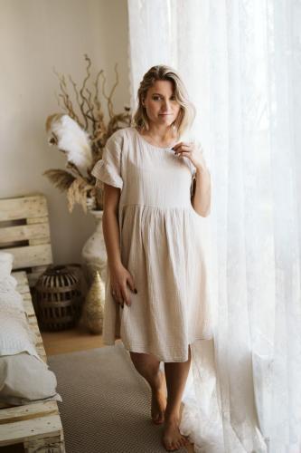 Fotografie ženy v krátkých béžových šatech